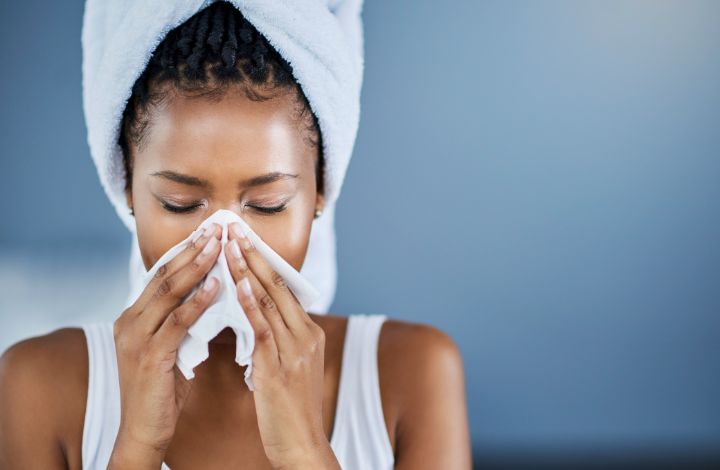 Freshly washed white bedding hanging outside in sunlight during spring allergy season