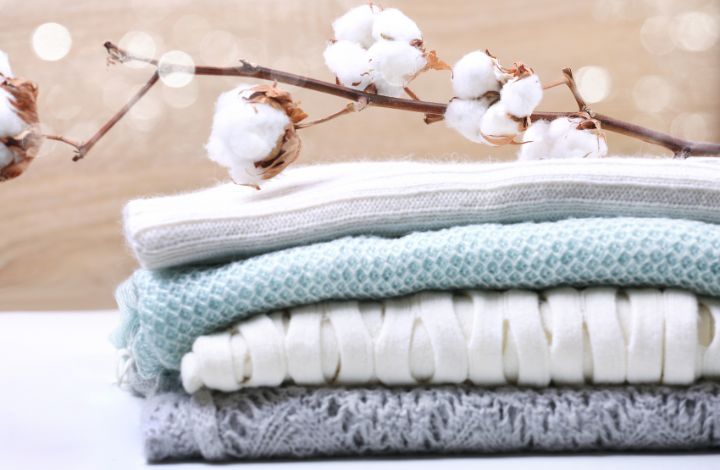 Freshly folded clothes with soft fabrics and neutral tones