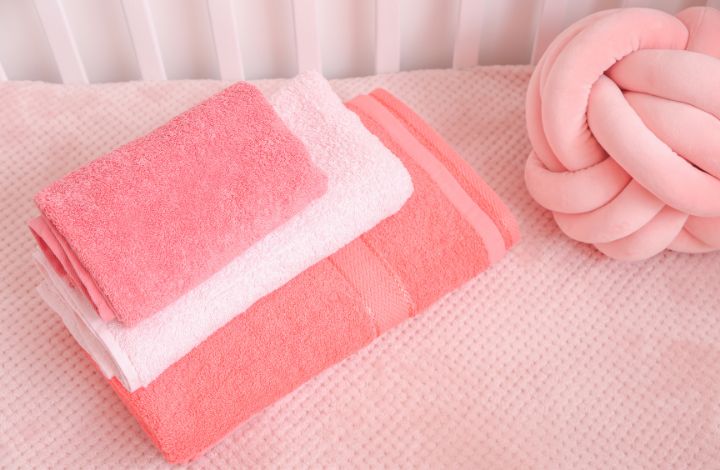 Soft, fluffy white towels folded neatly on a clean surface