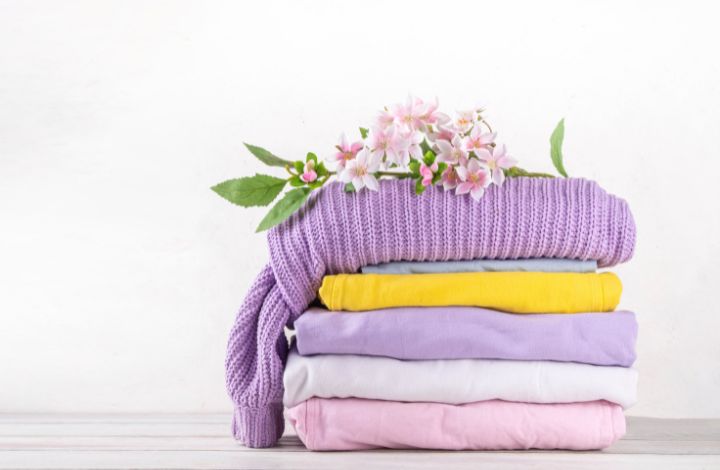 Fresh folded laundry and spring flowers representing wash dry fold laundry service in spring
